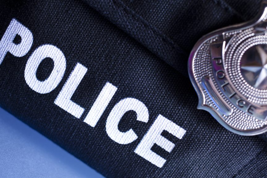 Law: Police bulletproof vest and badge.
